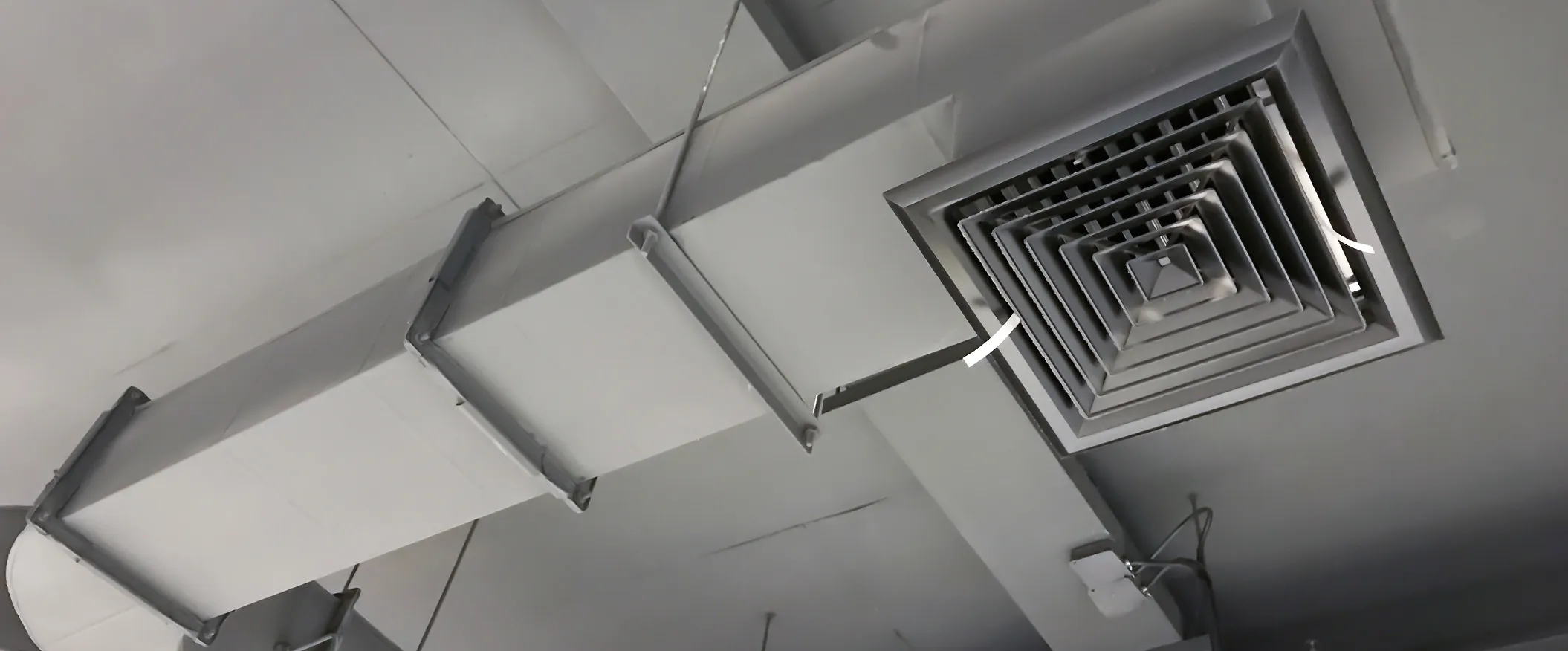 Industrial heating system with large boilers, pipes, and valves in a mechanical room.